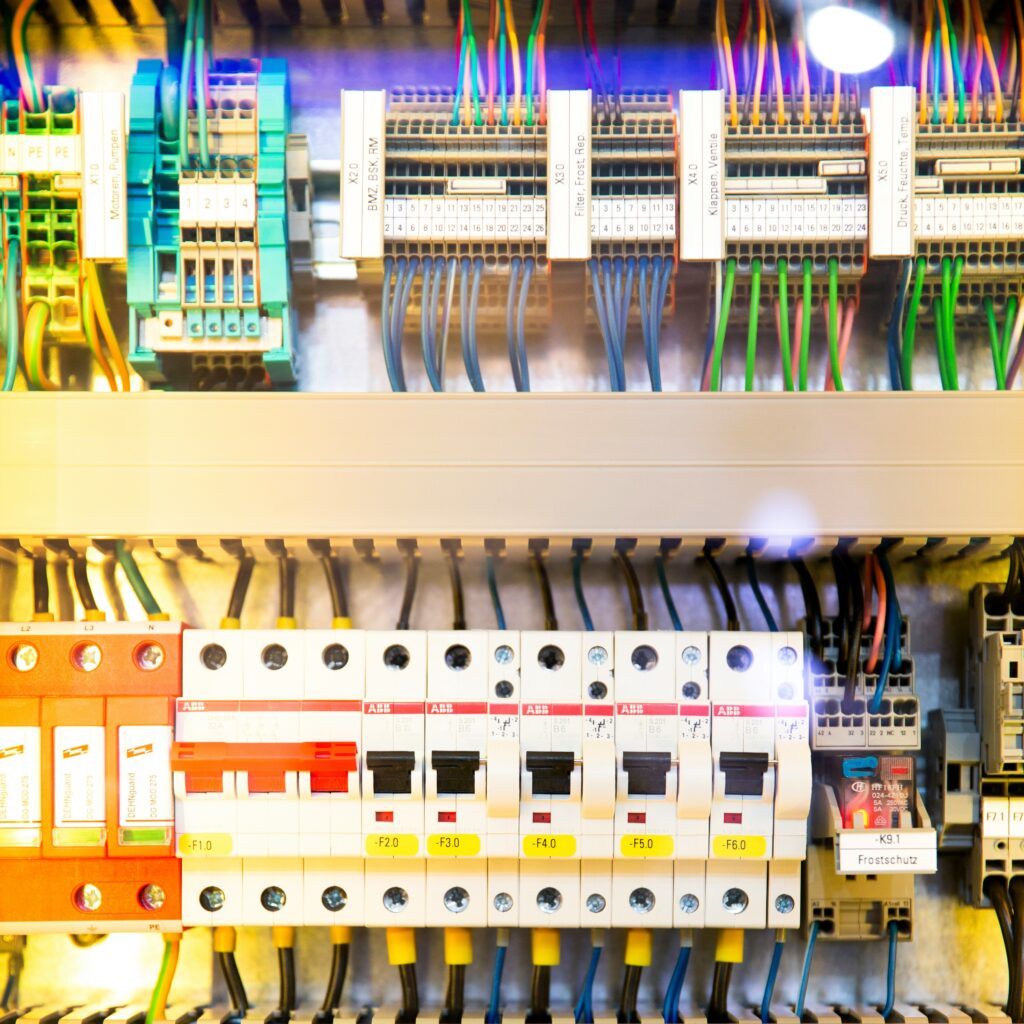 A close-up view of a complex electrical panel with various circuit breakers and connected wires.